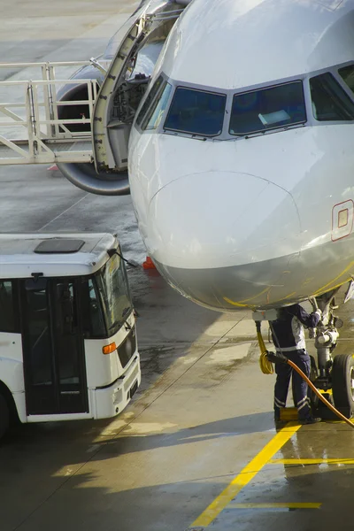 Passenger aircraft maintenance before flight at airport.