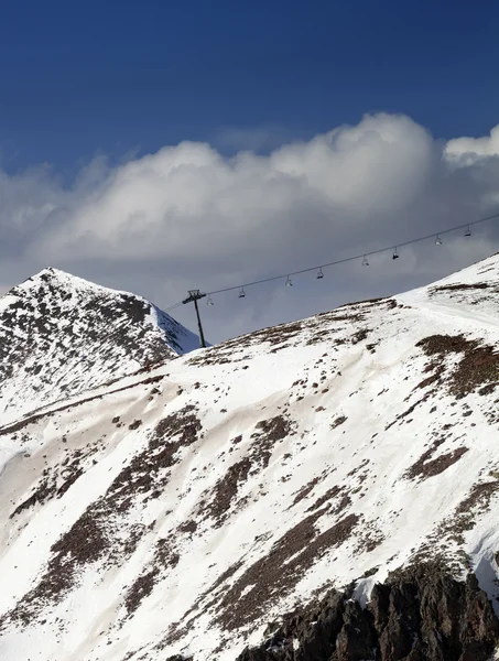 Off-piste slope and chair-lift in little snow year