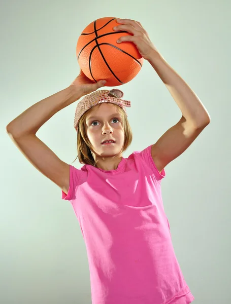 Child playing basketball and throwing ball