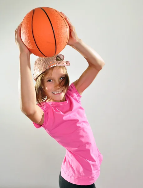 Child exercising with dumbbells and ball