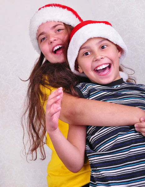 Happy children with Santa Claus red hats