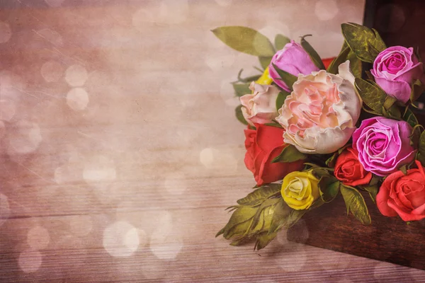 Wooden background with close up of flowers  in the box with free