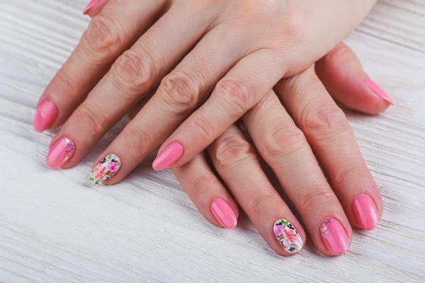 Light pink nail art with printed flowers