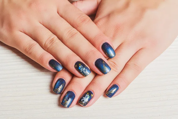 Dark blue nail art with gold stars