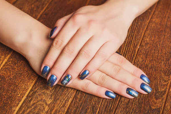 Dark blue nail art with gold stars