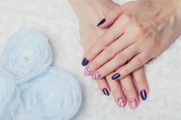 Nail art with purple and pink colors