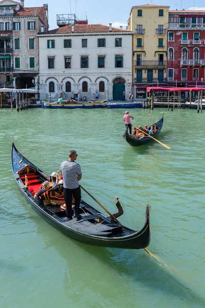 Gondolier rides gondola.