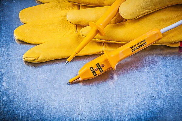 Yellow electrical tester, safety gloves