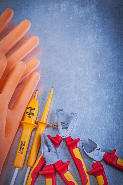 Gloves, tester, pliers and wire cutter