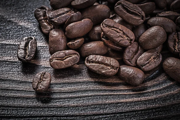 Coffee beans on vintage wood board