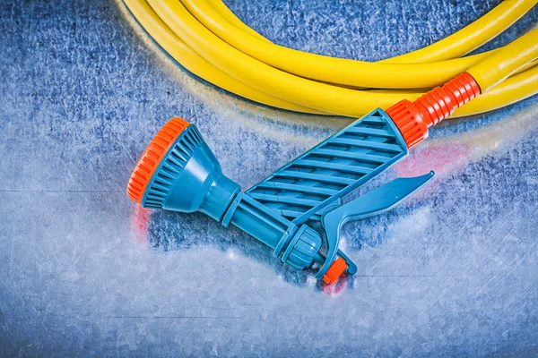 Garden hose with water spray nozzle