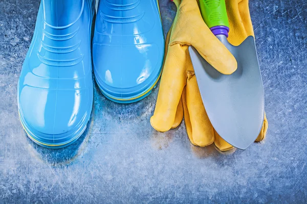 Gum boots, protective gloves and shovel