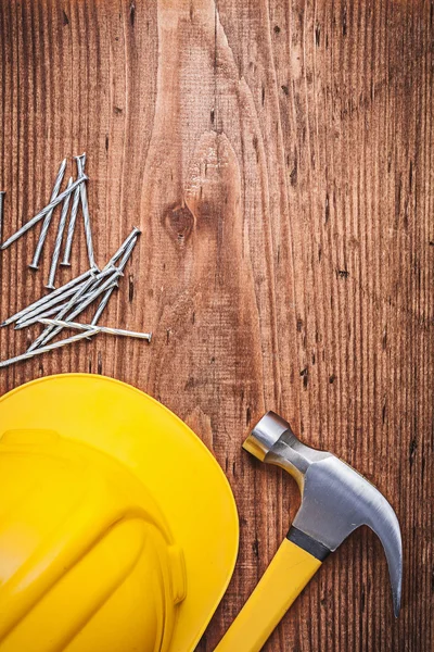 Hammer, construction nails and building helmet