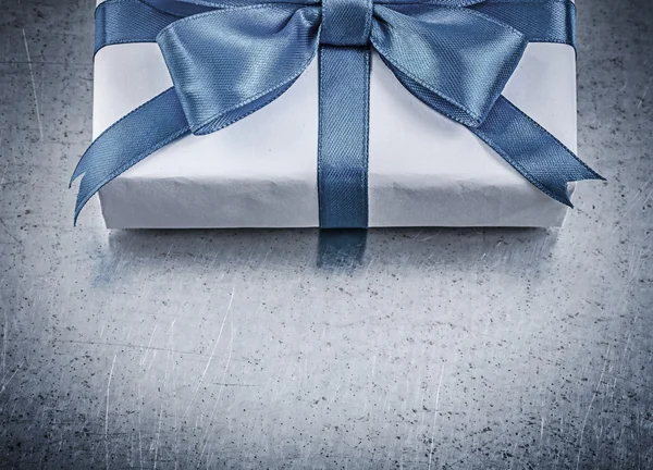 Present box with blue ribbon