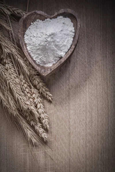 Bowl with flour and rye wheat ears