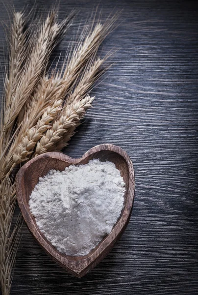 Bowl with flour and rye wheat ears