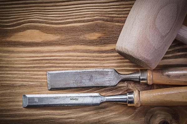 Wooden mallet chisels on vintage board