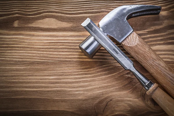 Claw hammer flat chisels on vintage wood board