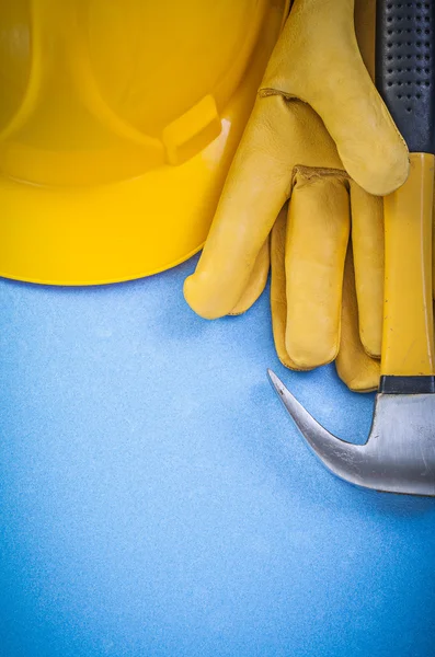 Claw hammer safety gloves hard hat on blue background constructi