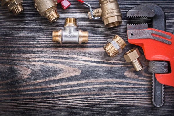 Set of plumbers tools on wooden board plumbing concept
