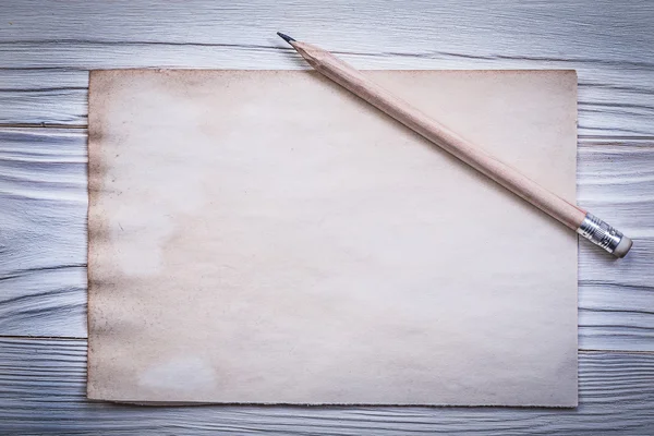 Vintage clean paper sheet pencil on wooden board