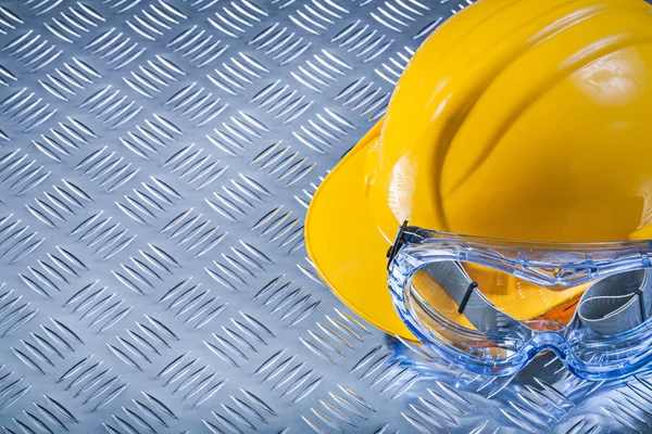 Safety spectacles building helmet on corrugated metal sheet copy