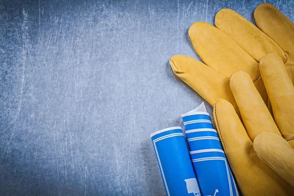 Leather gloves and engineering drawings