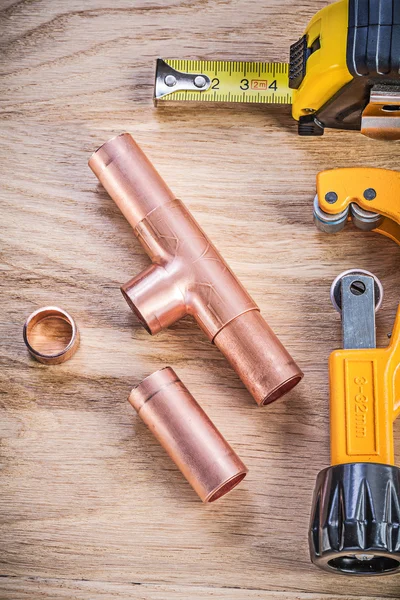 Copper water pipe cutter fixtures tape measure on wooden board v