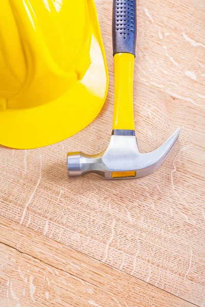 Yellow hardhat and claw hammer