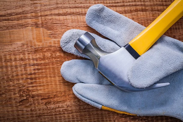 Claw hammer in protective glove