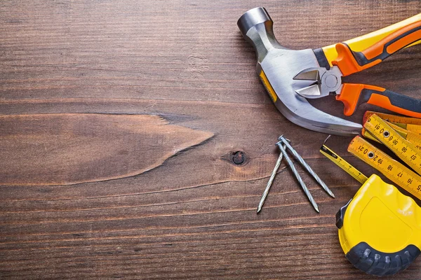 Construction tools on wooden background