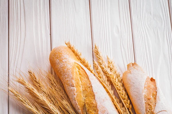 Two baguettes and ears of wheat