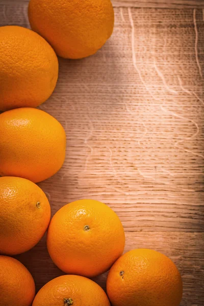 Orange fruits on wooden board