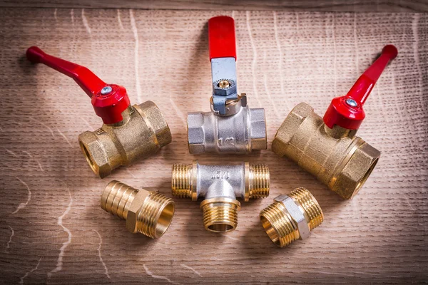 Brass Pipe Connectors On Wooden Board