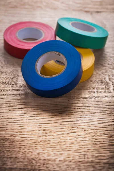 Rolls of insulating tape on wooden board