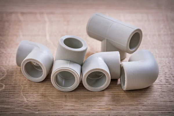 Pipe Fittings On Wooden Board