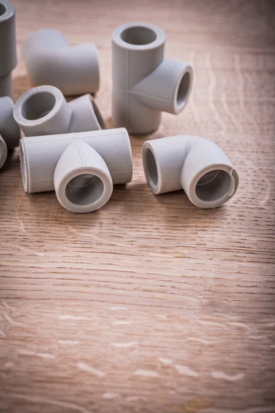 Pipe Fittings On Wooden Board