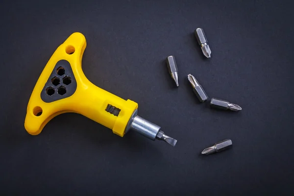 Yellow screwdriver with bits