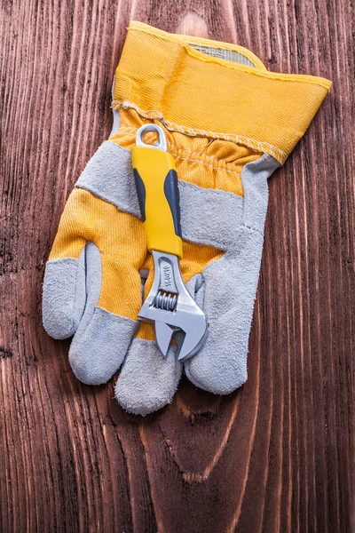 Adjustable spanner and protective glove