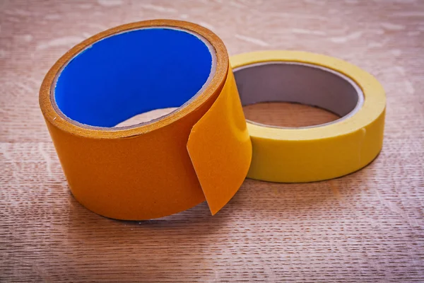 Rolls of wide and narrow duct tapes