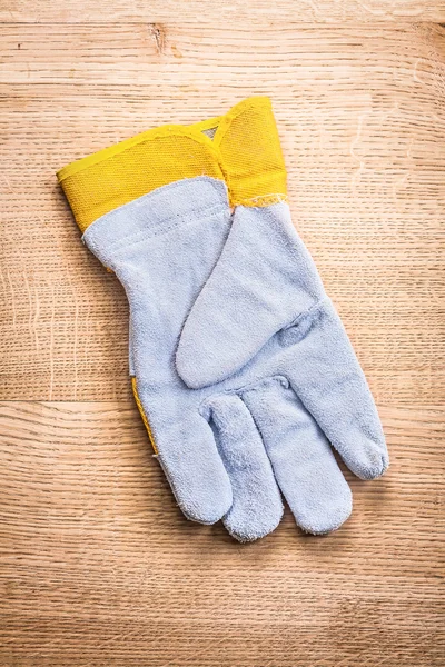 Protective glove on wooden board