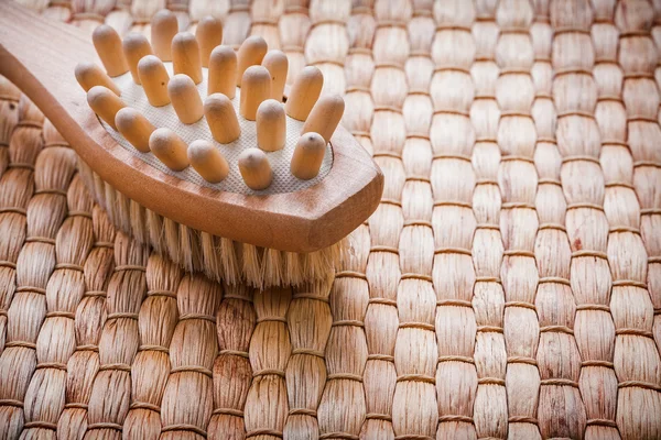 Wooden massager with scrubbing brush