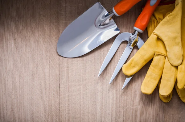 Safety gloves, trowel fork and spade