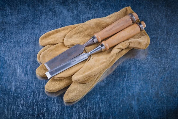 Flat chisels and leather protective gloves