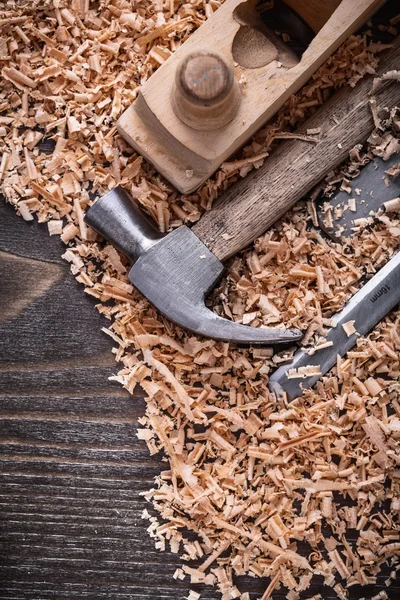Hammer, chisels wooden planer and shavings