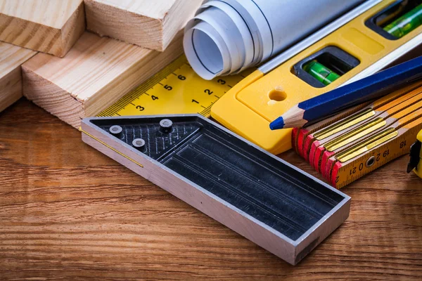 Square ruler, blueprints and wooden meter