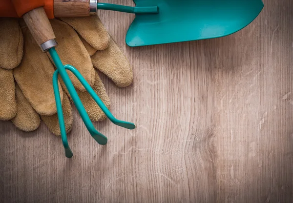 Working gloves, gardening trowel and rake