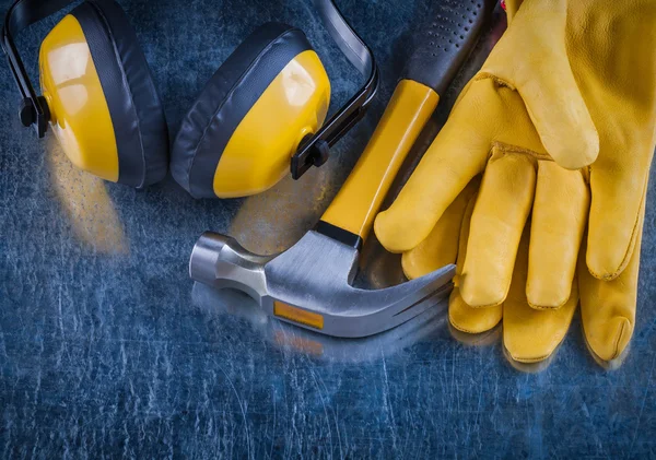 Safety yellow earmuffs, hammer and gloves