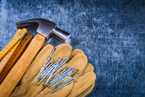 Protective gloves, nails and hammer
