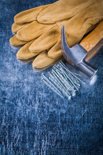 Safety gloves, nails and claw hammer